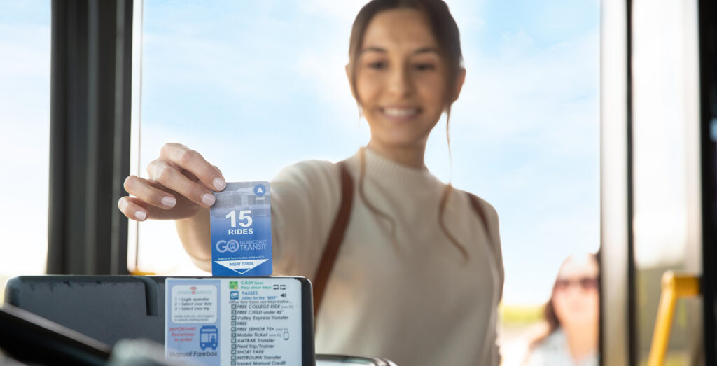 woman inserting her 15-ride pass into the farebox