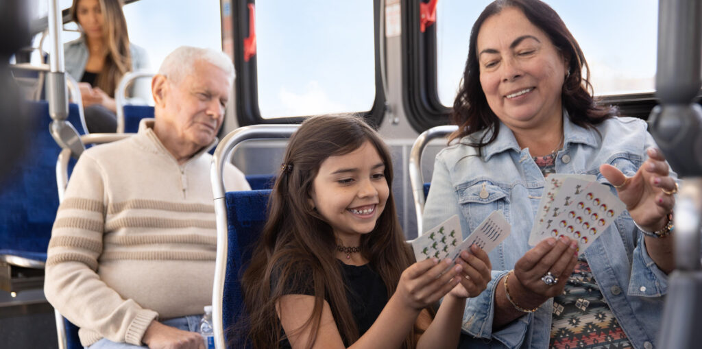 grandmother riding the bus with her grand-daughter